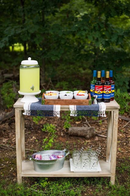 a picnic table with food and drinks on it