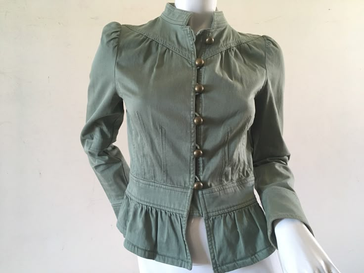 Marc Jacobs jacket Pretty little khaki cotton military inspired jacket. Officers collar, yoke neck, waisted with a peplum frill. Unlined. All the seams inside beautifully finished with a contrasting pretty blue cotton binding. It has some nice dart details on the sleeves and at the waist. Large round brass buttons. Size 4 US 36 EU 8 UK & AUS Bust 90cm Waist 72cm Centre front length 48cm Shoulder 9cm Sleeve 62cm A little fading down the length of the sleeves but otherwise in very good condition. Spring Cotton Utility Jacket With Stand Collar, Spring Military Style Fitted Tops, Fitted Military Tops For Spring, Fitted Military Utility Jacket For Fall, Fitted Khaki Button-up Utility Jacket, Spring Military Style Tops With Buttons, Fitted Cotton Utility Jacket With Buttons, Fitted Military Style Top For Fall, Fitted Khaki Utility Jacket For Spring