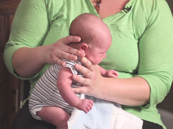 a woman holding a baby in her arms