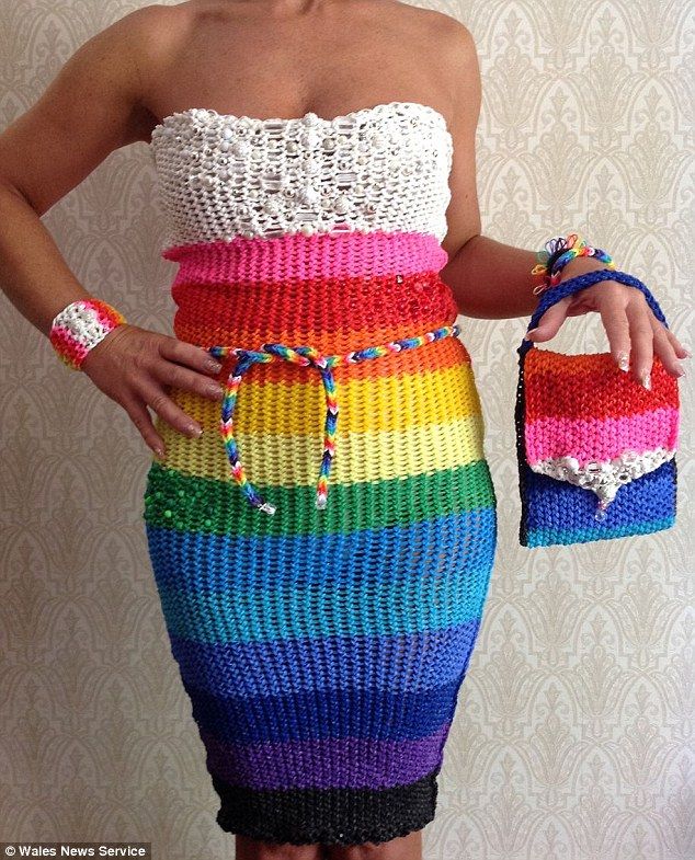 a woman in a rainbow colored dress holding a purse