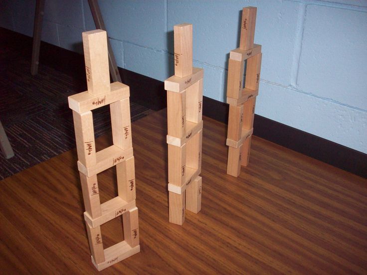 three pieces of wood sitting on top of a hard wood floor next to each other