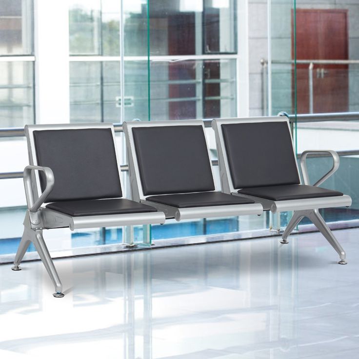 two chairs sitting next to each other in front of a glass wall with windows on both sides