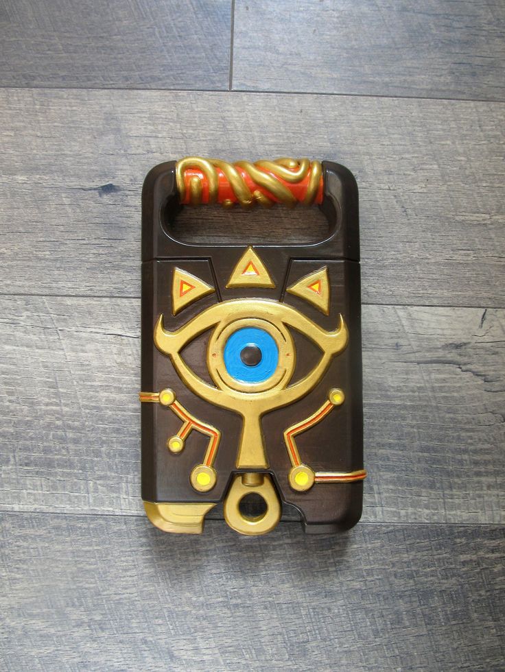 a phone case with an evil eye on the front and back cover, sitting on a wooden floor