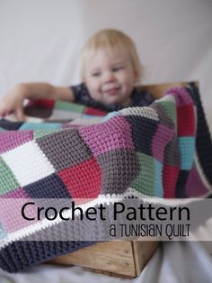 a child is sitting in a chair holding a crochet blanket