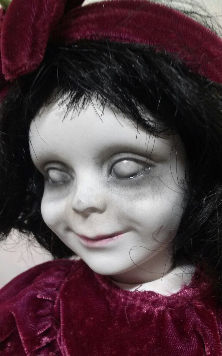 a close up of a doll with black hair