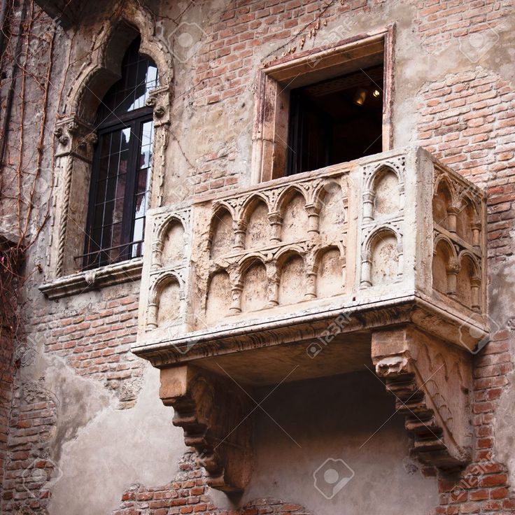 an old brick building with balcony and balconies stock photo - 957982