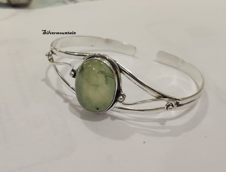 Prehnite Bangle*925 Sterling Silver Bangle*Gemstone Bangle*Cuff Bangle*Beautiful Gemstone Bangle*Designer Bangle*Gift For Girls & Women* ---------------------------------------------------------------------------------------------------------------------------------------------------- Description Metal :- 925 Sterling Silver Style : Bangle  benefits of prehnite stone Prehnite alleviates nightmares, phobias and deep fears, uncovering and healing the dis-ease that creates them. It is a stone for d Luxury Sterling Silver Bangle With Natural Stones, Gem Bangle, Fake Jewelry, Silver Bracelets For Women, Bracelets Design, Gemstone Bangle, Sterling Silver Bangle, Bangle Designs, Jewelry Lookbook