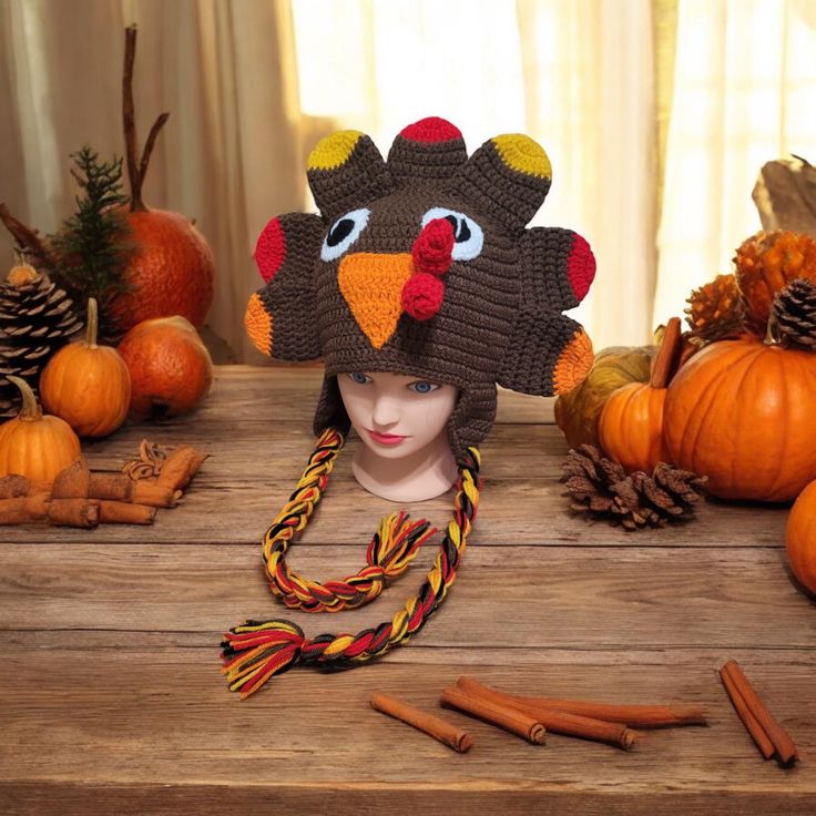 a knit turkey hat sitting on top of a wooden table