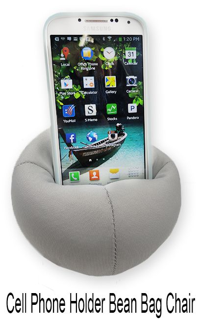 a cell phone sitting on top of a pillow in the shape of a boat,