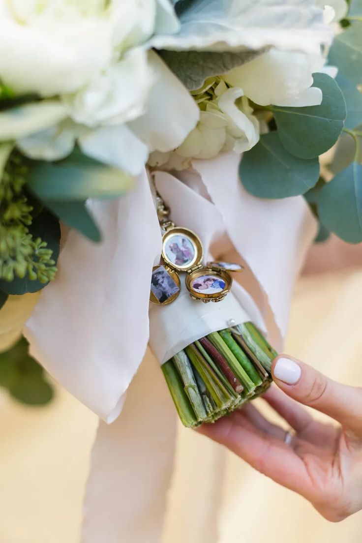 the bride's bouquet is wrapped in white ribbon