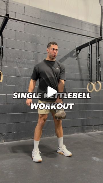 a man standing in front of a gym wall with the words single kettlebell workout