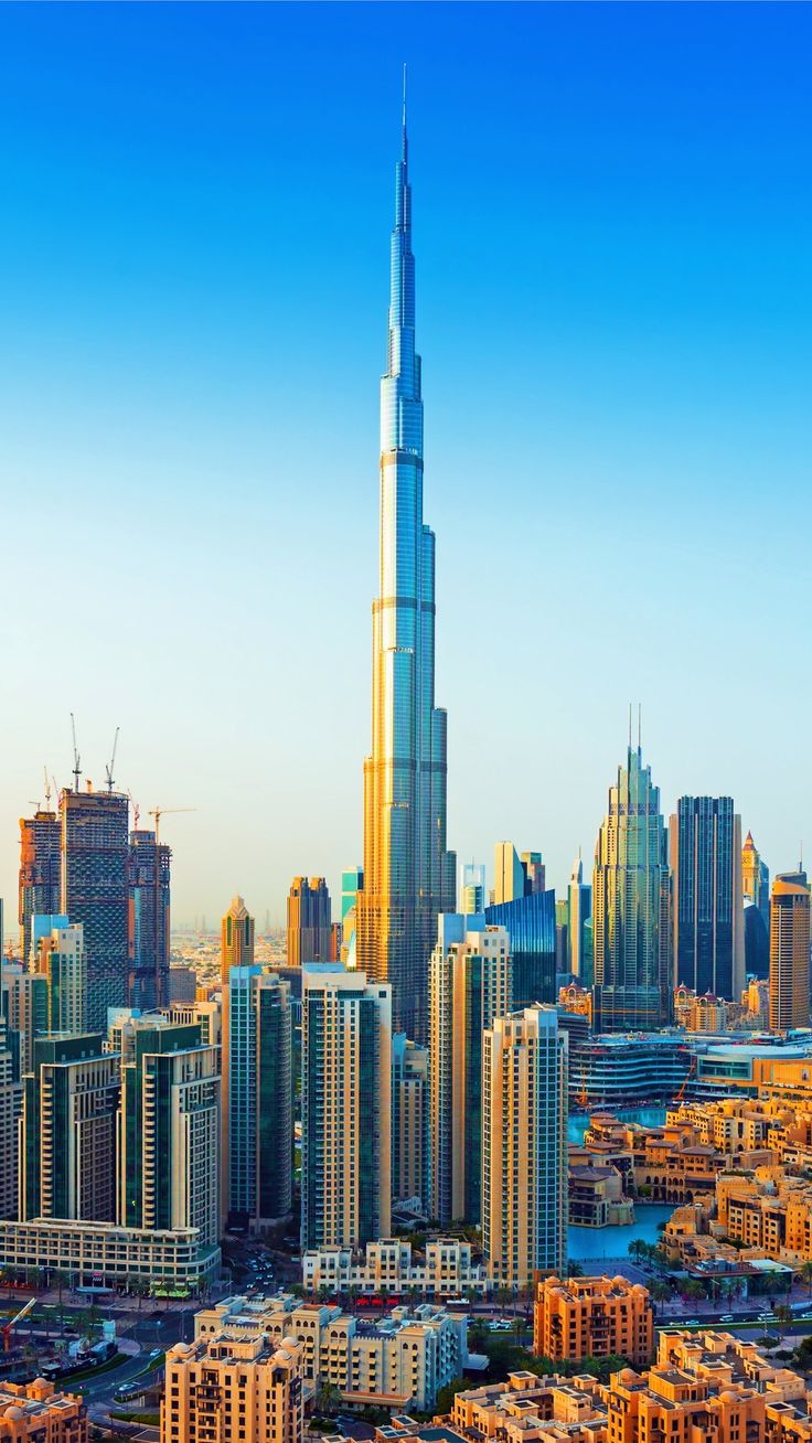 an aerial view of the burj tower and surrounding skyscrapers in dubai, united kingdom