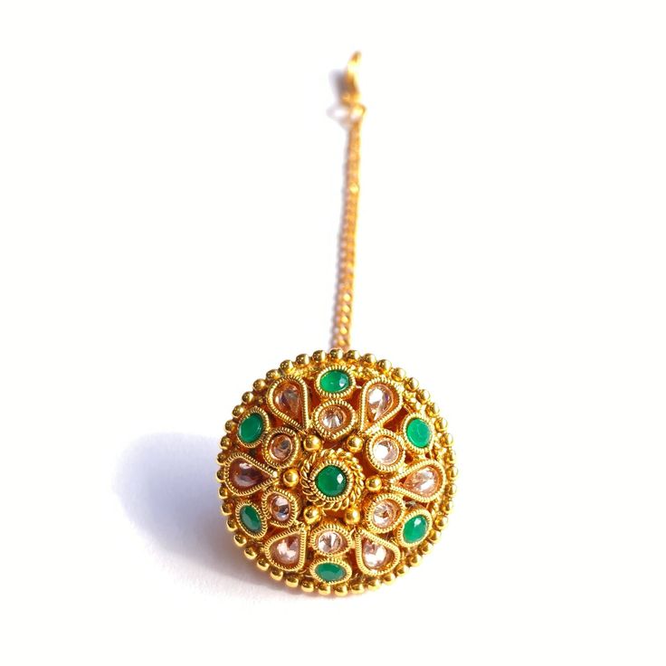 Name Of Product:- Antique Borla (Indian Fashion Jewelry) Width: 3 centimeter Shipping Processing Time: 1-3 days Delivery Time: Depend on Country High-quality Borla style Kundan tika. The tika is Rajasthani style Borla. Ideal for wedding, mehndi ceremony. Absolutely stunning. Finished off beautifully by adding Polk. To view our latest collection of Borla, Mang Tikka, and Hair Accessories please click the below link. https://www.etsy.com/uk/shop/HemrajJewellers?ref=seller-platform-mcnav&sectio Handmade Gold Tikka As Gift, Gift Tikka With Intricate Design, Round Meenakari Tikka As Gift, Round Tilla Tikka As A Gift, Bohemian Gold Tikka As Gift, Bohemian Gold Tikka For Gift, Green Jewelry With Motifs For Gift, Festive Green Jewelry With Motifs, Green Intricate Design Tikka For Festivals