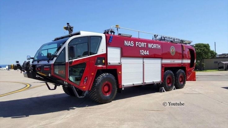 a red and white fire truck parked in a parking lot