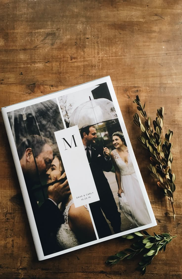 a wedding album sitting on top of a wooden table