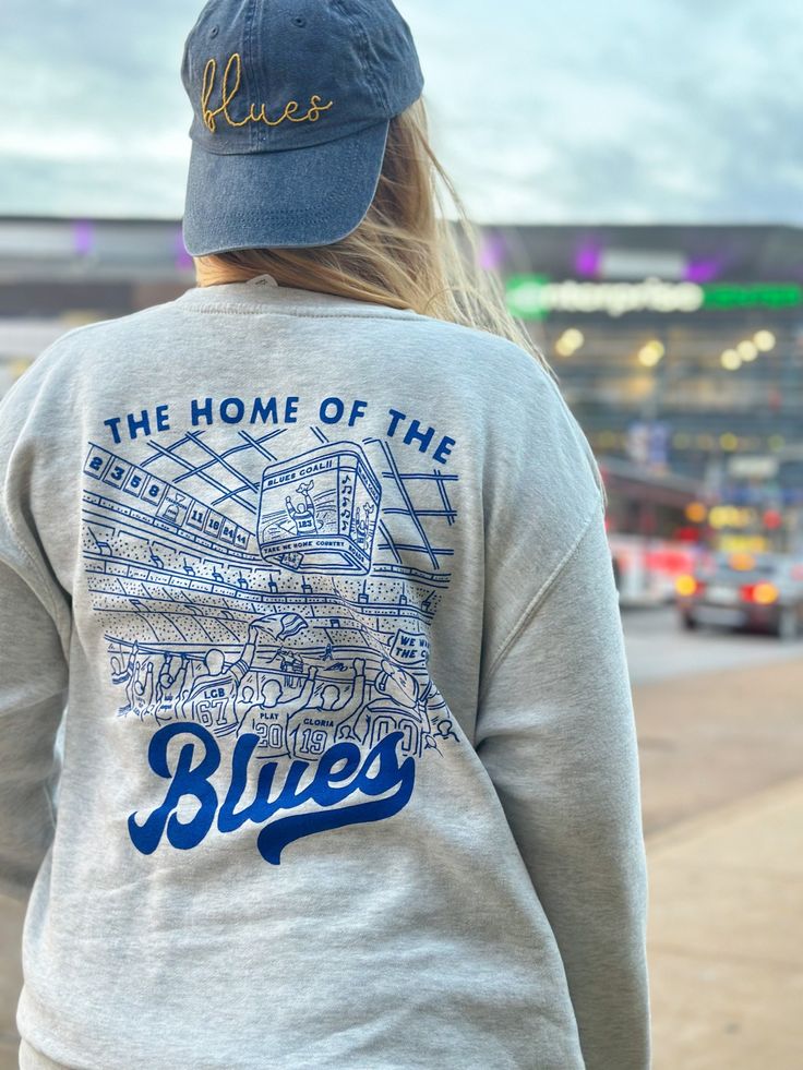 Extra soft, professionally screen printed St. Louis Hockey sweatshirt. These oatmeal heather sweatshirts feature a blue screen printed design on the front and back of the shirt.  Get the perfect gift for your favorite Blues fan with this vintage style hockey design. The back design features some special details only a true fan would recognize: a nod the towel guy, retired Blues numbers, Louie, Gloria, and more.  Fit: These are are true unisex sizing. Size up 1-2 sizes for an oversized look. See Throwback Cotton Sweatshirt With Screen Print, College Throwback Style Sweatshirt With Screen Print, Casual Screen Print Sweatshirt For Fans, Casual Sweatshirt With Screen Print For Fans, Casual Pre-shrunk Sweatshirt For Fan Merchandise, Cotton Fan Apparel Sweatshirt, Casual Pre-shrunk Sweatshirt For Fans, Cotton Sweatshirt For Fan Merchandise, Blue Urban Sweatshirt For College