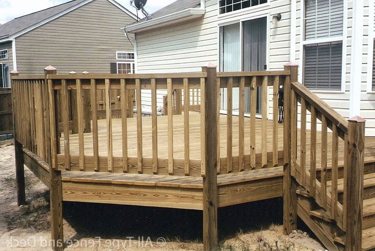 a wooden deck in front of a house