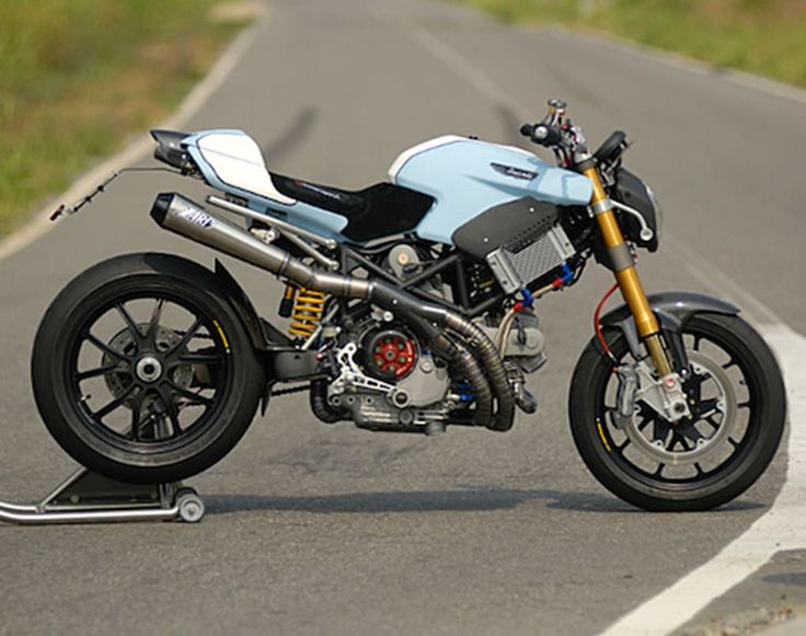 a blue and white motorcycle parked on the street