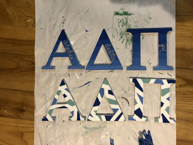 a piece of paper with the word ait on it and blue letters above it