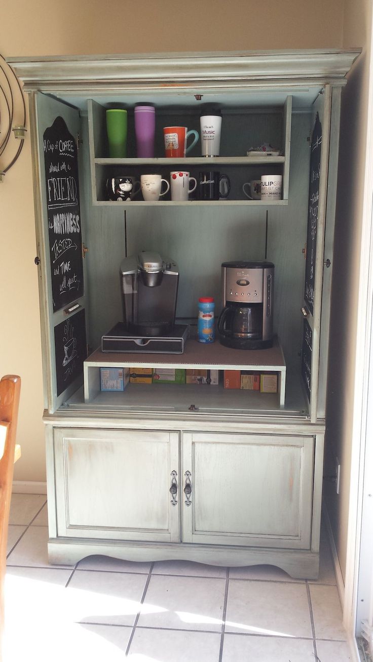 an old cabinet with coffee maker and cups on it