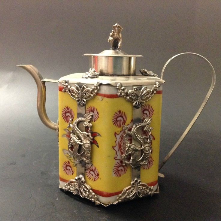 a silver tea pot with an ornate design on it