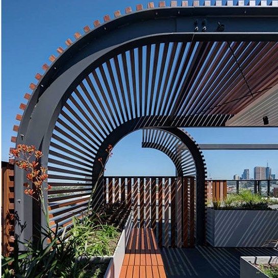 an outdoor area with wooden walkways and plants