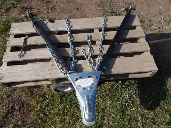 a cow skull with chains attached to it sitting on top of a pallet in the grass