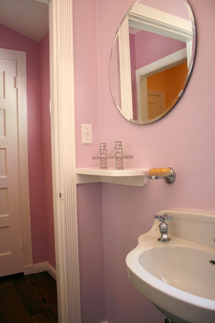 a white sink sitting under a mirror in a bathroom