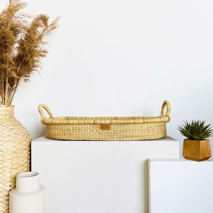 a wicker basket sitting on top of a white shelf