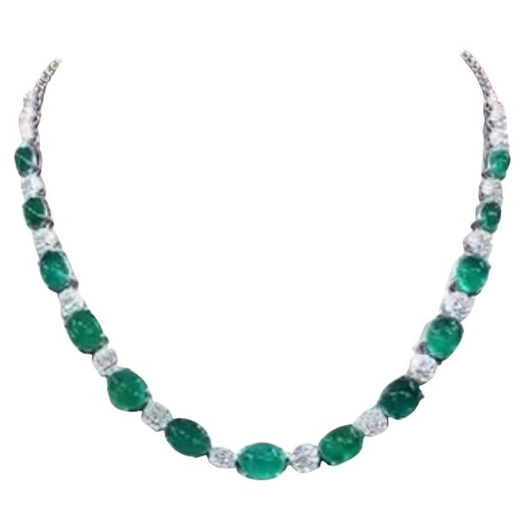 A stunning necklace features a breathtaking Emeralds . The necklace is further adorned with vibrant emeralds and diamonds, adding a touch of glamour and sophistication to the already magnificent piece. Truly a statement of luxury and style. The perfect combination to add a touch of grace and allure to any occasion. Adorn your neck with these magnificent works of art , where vivid hues and unparalleled brilliance combine to create a statement accessory that will captivate all who lay eyes on it. Magnificent necklace come in 18k gold with 13 pieces of Natural Zambian Emeralds, in perfect oval cut cabochon, in vibrant green, of 38,00 carats, and 194 pieces of Natural Diamonds of 4,80 carats, F color VS Clarity, very sparkly. Handcrafted by artisan goldsmith. Complete with report. Extremely hi Luxury Oval Emerald Fine Jewelry Necklace, Exquisite Luxury Oval Emerald Necklace, Luxury Gold-plated Emerald Necklace, Luxury Drop-shaped Emerald Necklace, Luxury Fine Jewelry: Polished Emerald Necklace, 18k Gold Necklace, Zambian Emerald, Expensive Jewelry, Zambia