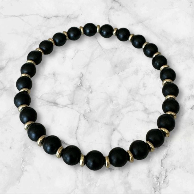 Indulge in a touch of luxury with our Black Onyx Gemstone Bead Stretch Bracelet. This elegant bracelet features beautifully smooth and polished black onyx gemstone beads, creating a timeless and sophisticated look. Perfect for any occasion, this bracelet adds a touch of glamour and refinement to any outfit. Luxury Black Beads Bracelets, Black Stretch Bracelet With Polished Beads, Black Onyx Beaded Bracelets With Polished Beads, Black Gemstone Beads Rosary Bracelet, Elegant Black Rosary Bracelet With Round Beads, Black Gemstone Beads Stretch Bracelet, Black Stretch Bracelet With Gemstone Beads, Black Gemstone Bead Bracelet, Black Onyx Stretch Bracelet With 8mm Beads