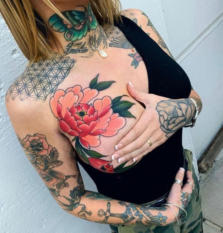 a woman with tattoos on her chest and arm