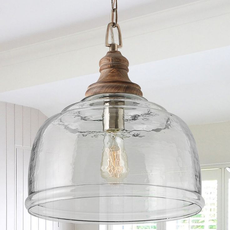 a clear glass light fixture hanging from a ceiling