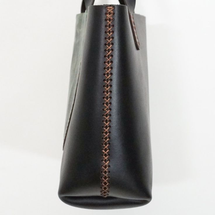 a black leather bag hanging from the ceiling