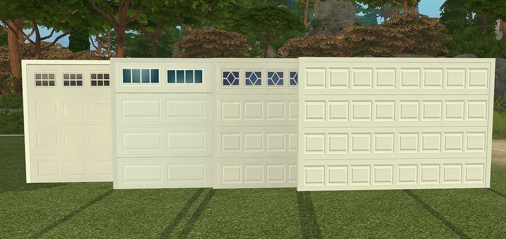 three white garage doors sitting next to each other on top of a grass covered field