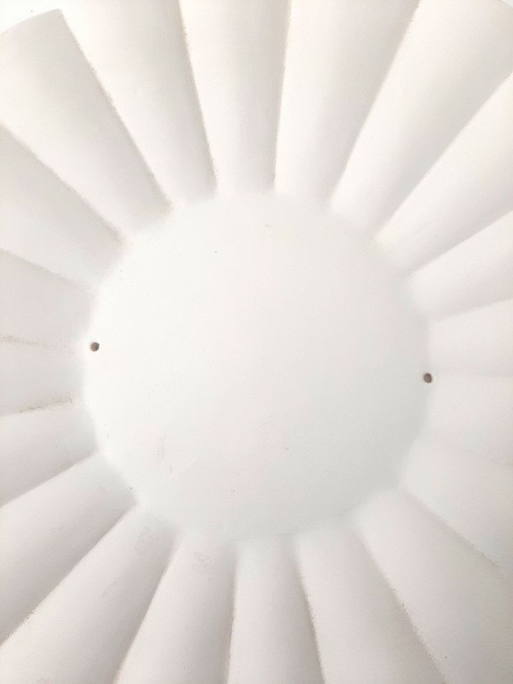 the underside of a large white object with very little light coming from it's center