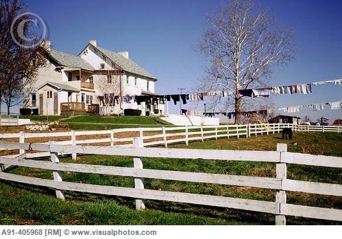 an old farm house with clothes hanging out to dry