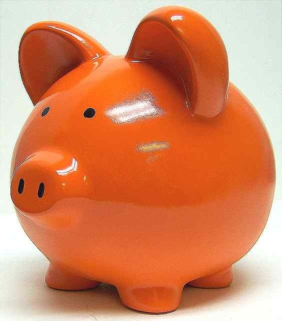 an orange piggy bank sitting on top of a white table