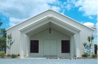 a large white building with two doors and windows