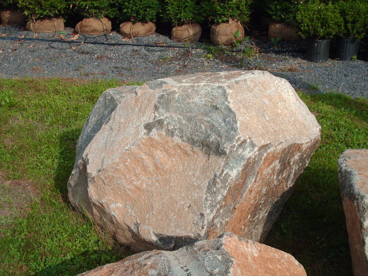 two large rocks sitting on top of green grass