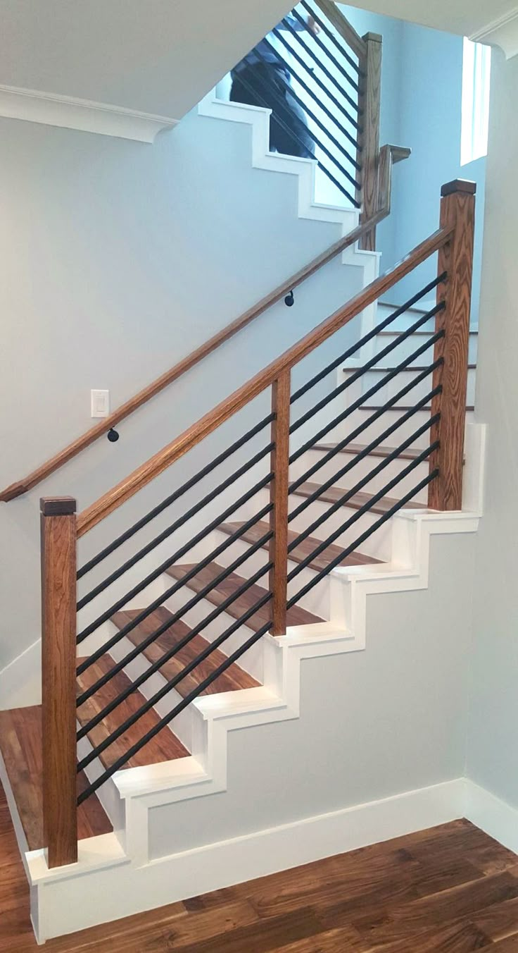 a stair case with wooden handrails in a house