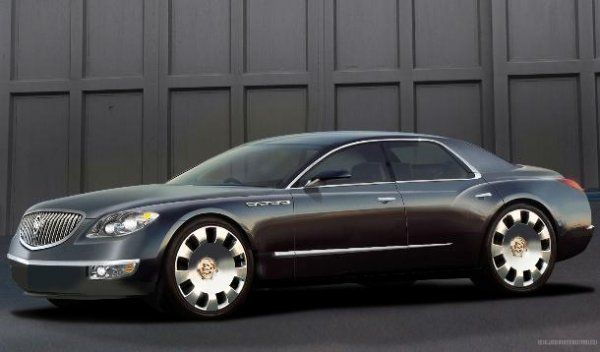 a black car parked in front of a garage door next to a tall gray building