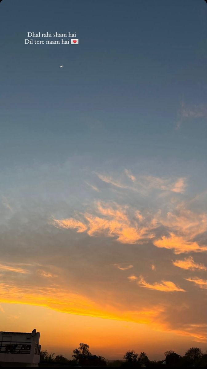 an airplane flying in the sky at sunset