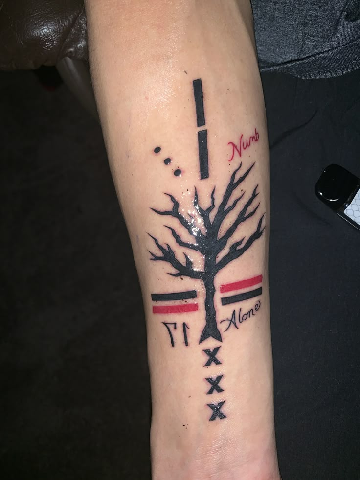 a person with a tattoo on their arm that has a tree and arrows in it