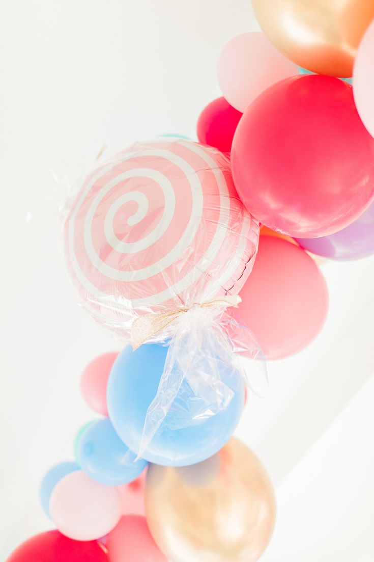 there are many balloons in the shape of a lollipop on top of each other