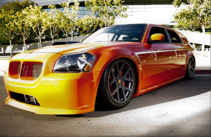 an orange and yellow sports car parked in a parking lot