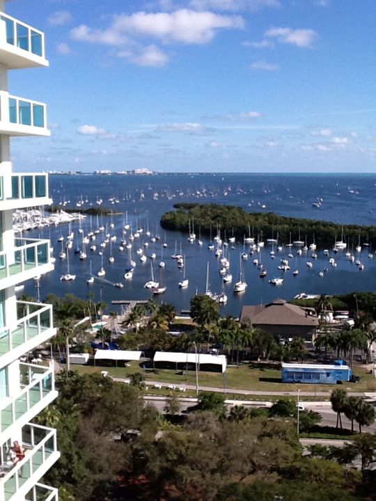 an aerial view of boats in the water from a high rise apartment building overlooking a marina