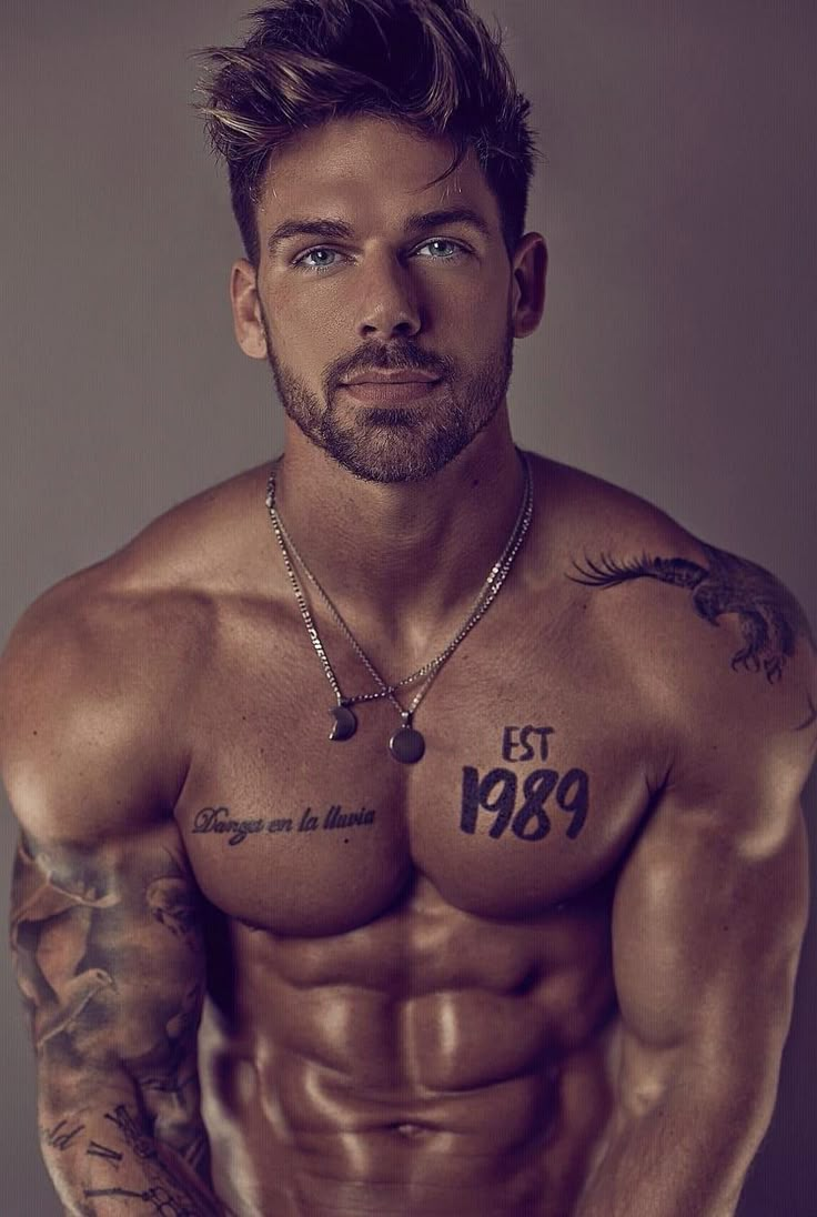 a shirtless man with tattoos on his chest