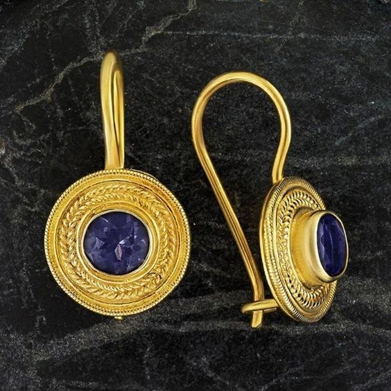 Handcrafted of a tiny disc of filigree thread, this classic Greek design highlights the beauty of a single amethysts are subtle yet undeniably brilliant. 24k gold over sterling silver; hinged backs. Size: 7/8 Inches. Handmade 22k Gold Round Jewelry, Ceremonial Gold Gemstone Earrings, Byzantine Style Gold-plated Round Jewelry, Byzantine Gemstone Jewelry For Gift, 22k Gold Filigree Round Jewelry, 22k Gold Filigree Jewelry, Byzantine Style Round Gemstone Jewelry, Dainty 22k Gold Round Jewelry, Dainty 22k Gold Jewelry