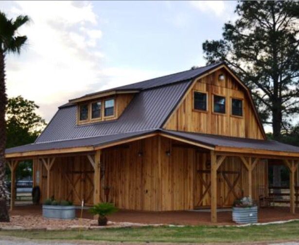 a large wooden barn with a metal roof